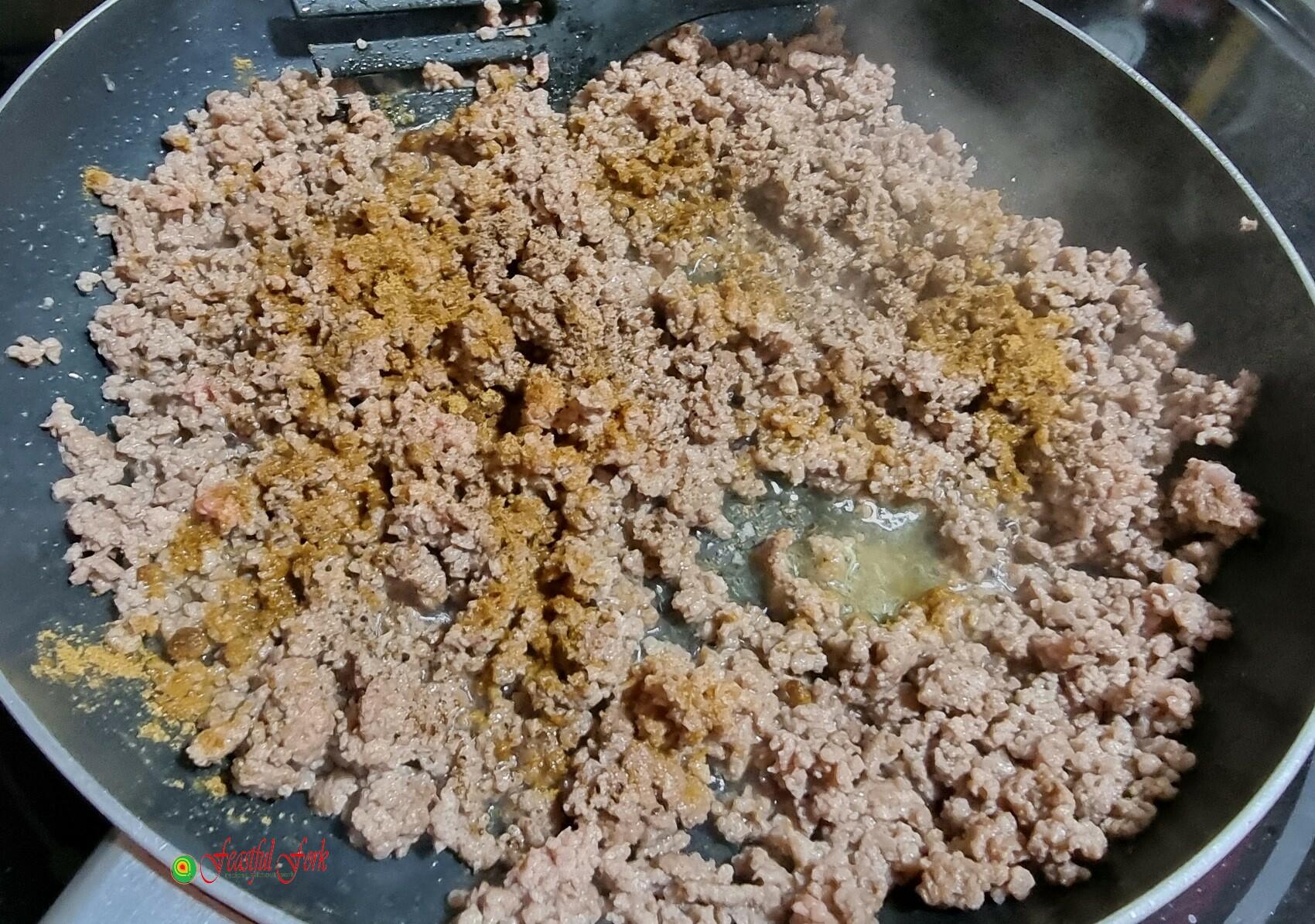ground beef on pan with spices
