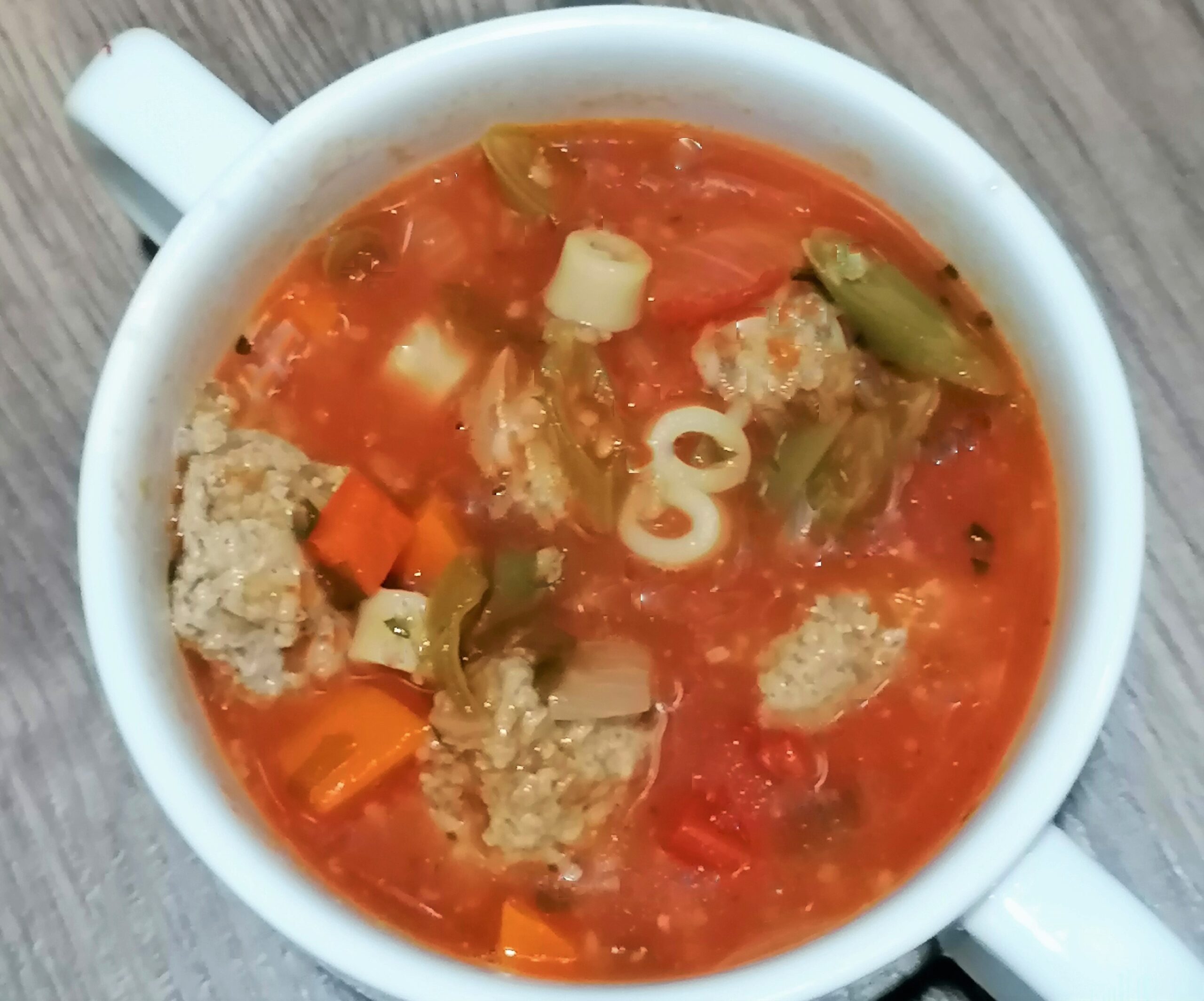 Tomato-based vegetable soup with meatballs