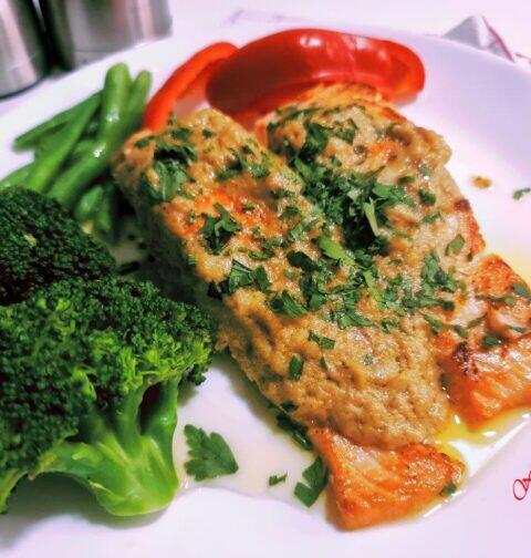 Creamy salmon slices with herb toppings and blanched broccoli