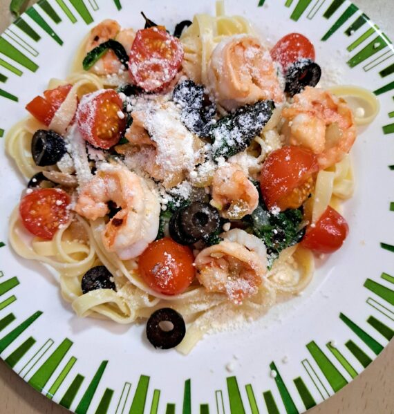 Shrimp and Pasta with Spinach on a Plate