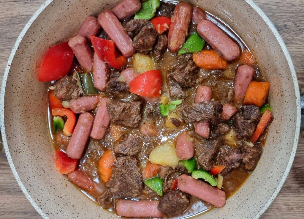 Beef afritada with hotdogs in a casserole